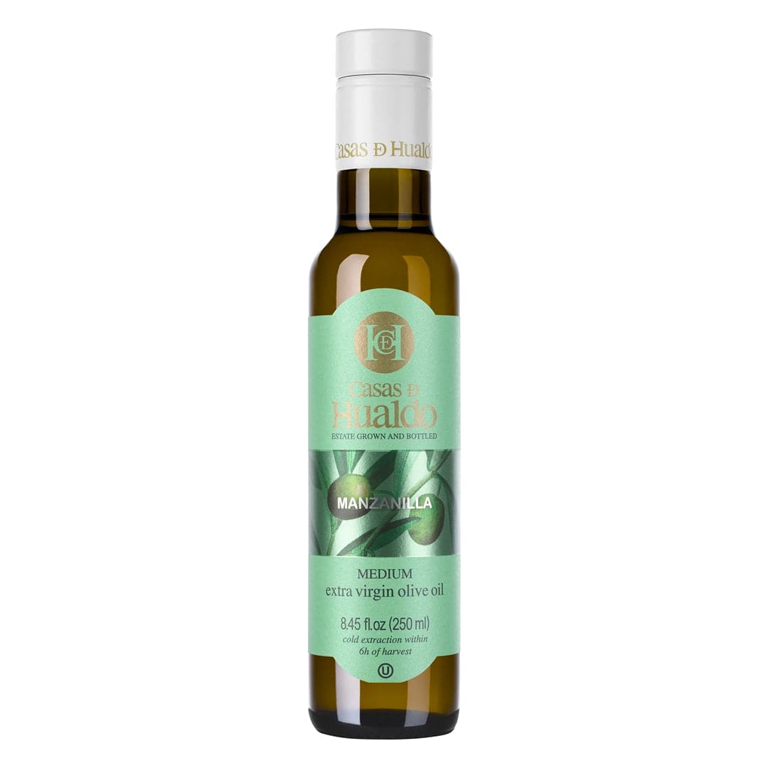 A 250 ml bottle of CASAS DE HUALDO Extra Virgin Olive Oil Manzanilla features an elegant olive design beside the distinguished Casas de Hualdo brand name.