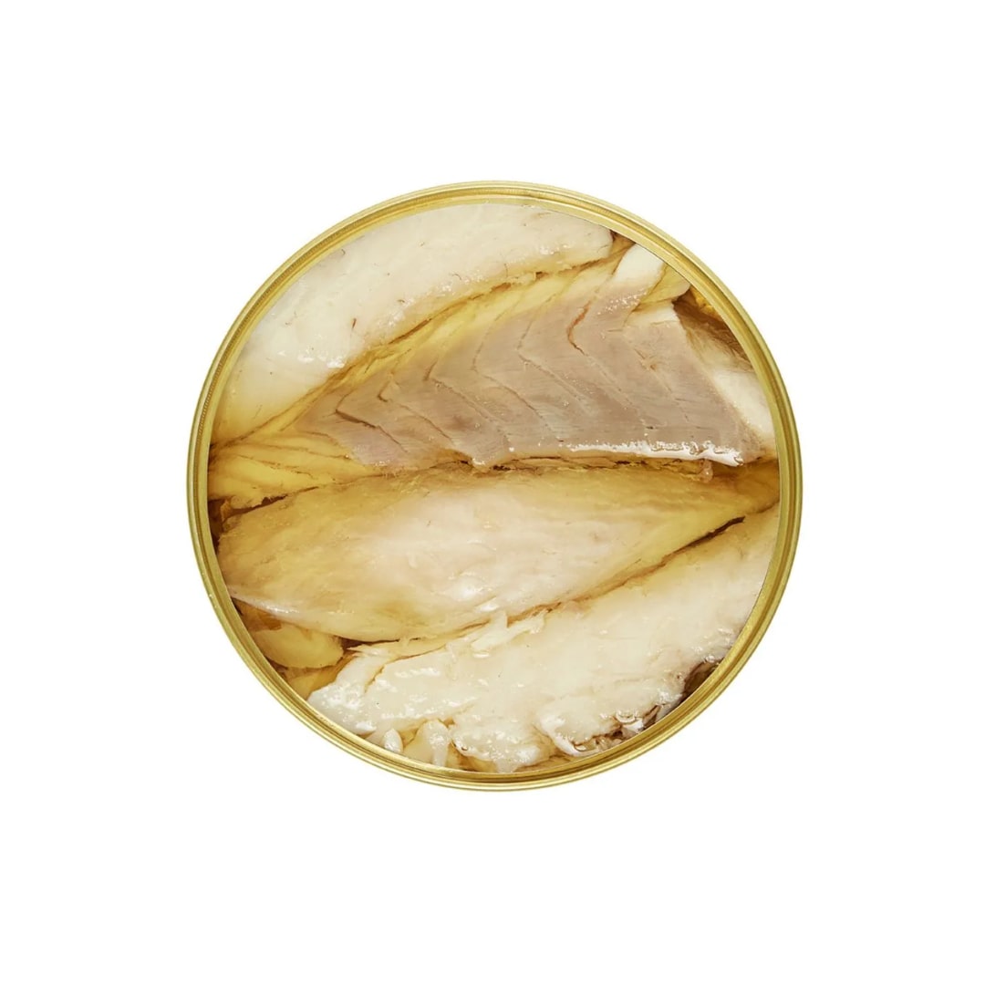 An open can of Los Peperetes Sea Bass Fillets glistens in rich olive oil, showcased against a metallic rim, viewed from above on a white background.